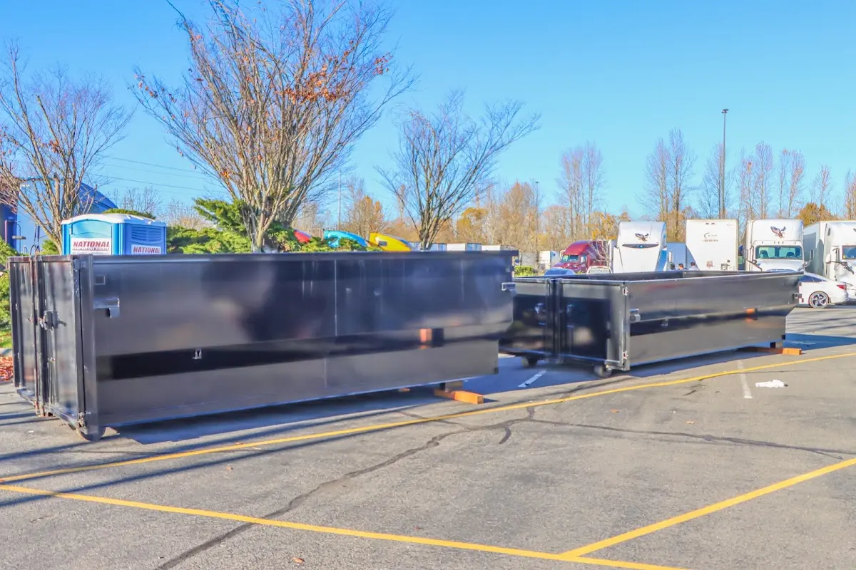 Professional dumpster rental service with roll-off container on residential driveway in Media